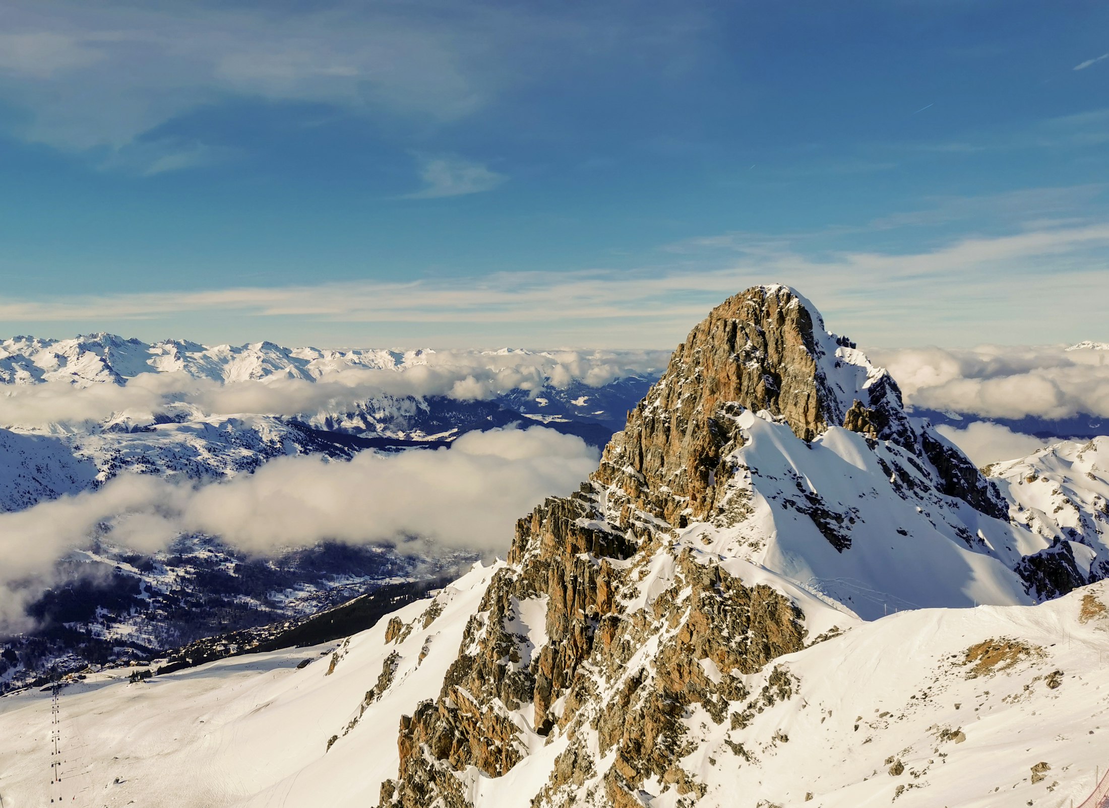 A snow-covered alpine peak under a clear blue sky