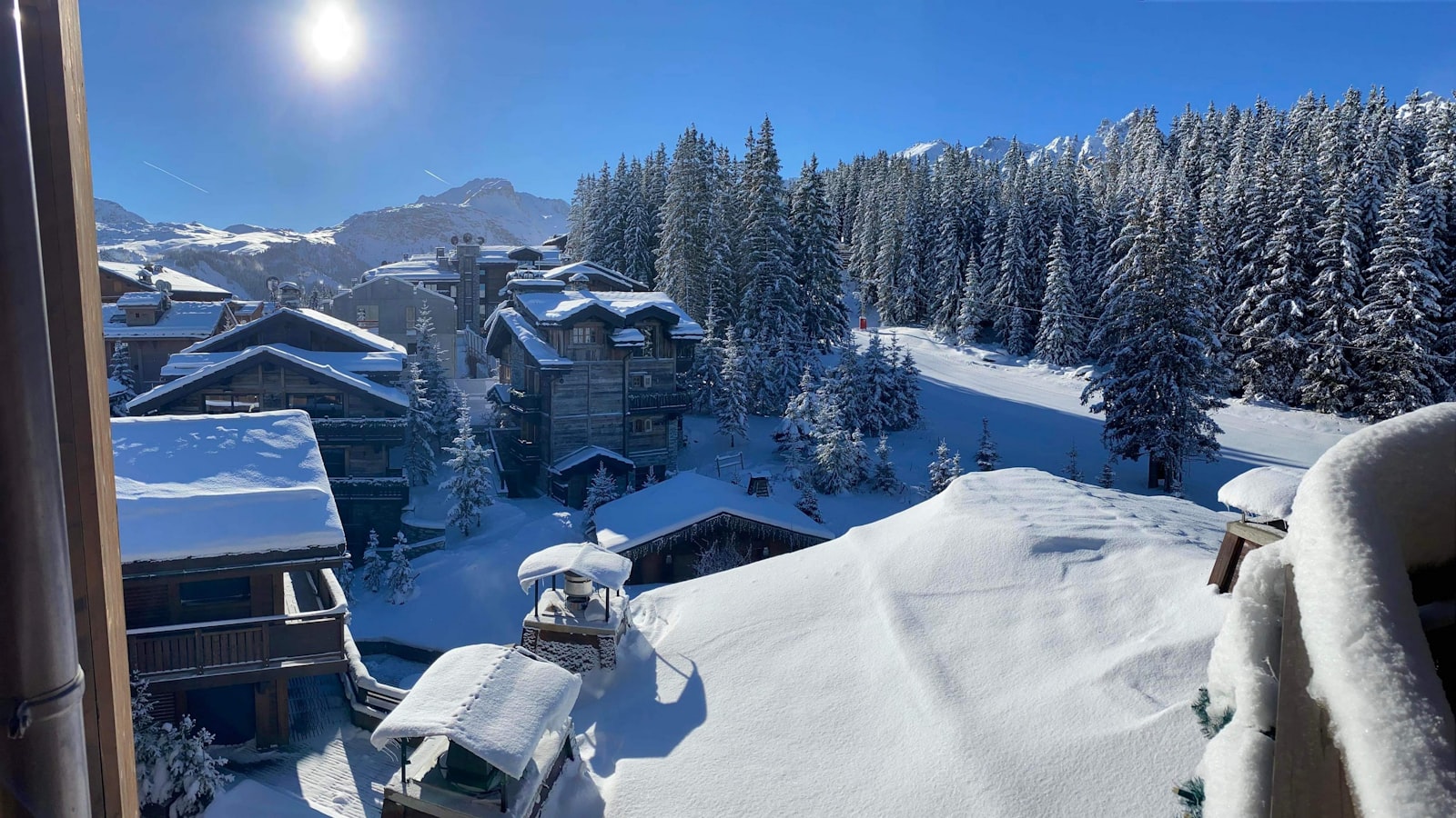 The snow-covered resort of Courchevel seen through a window