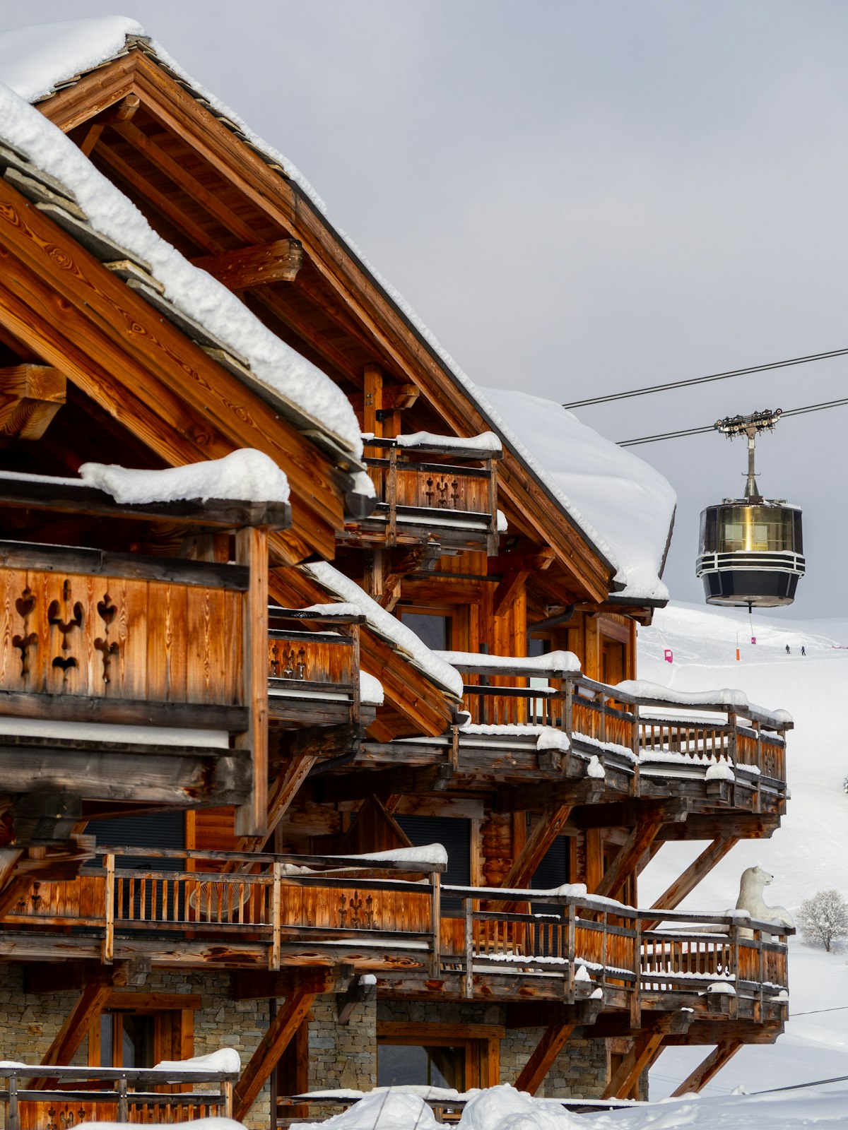 A gondola rising above the rooftops of Courchevel