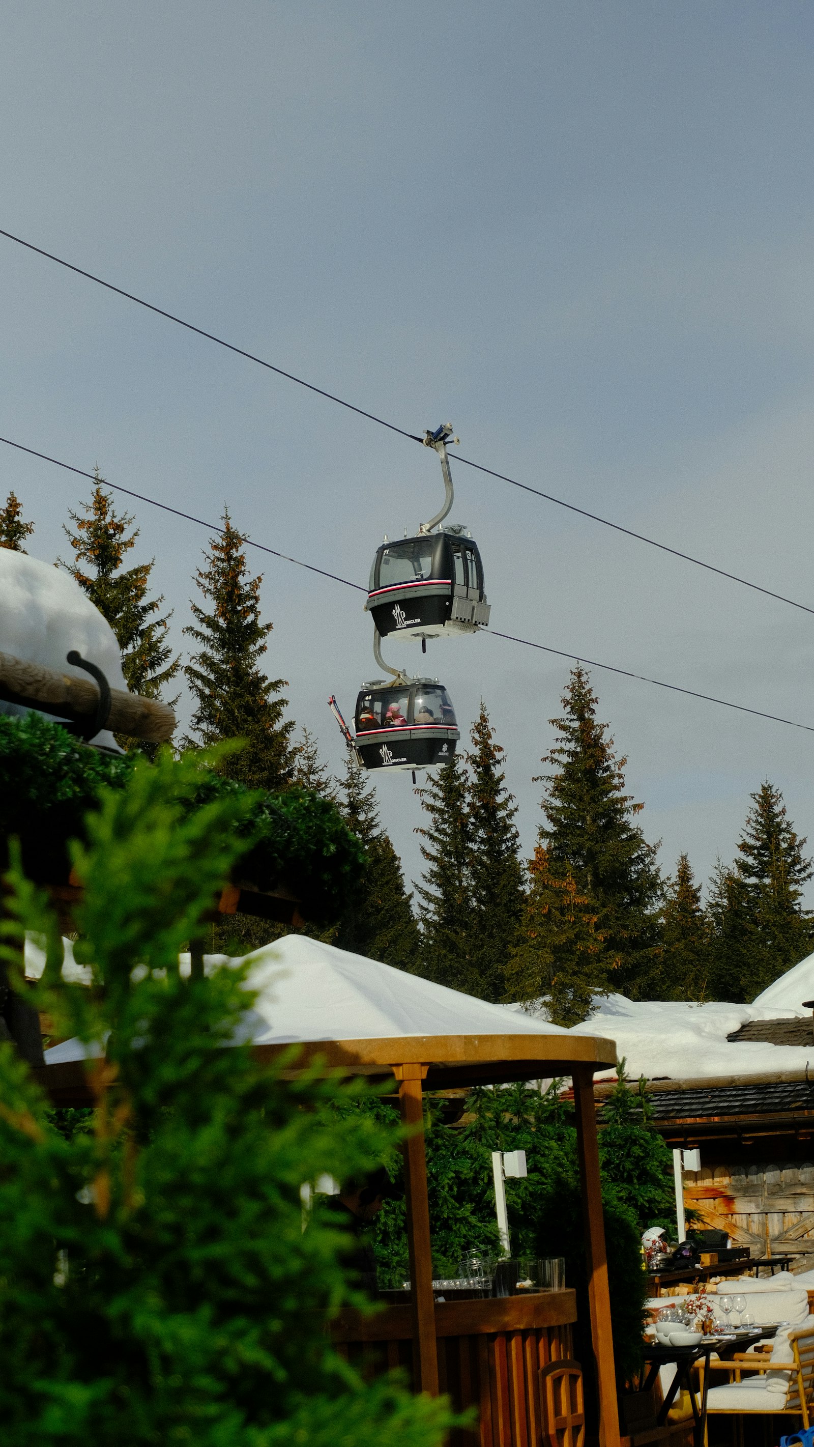 A ski lift line ascending over a snow-covered mountain