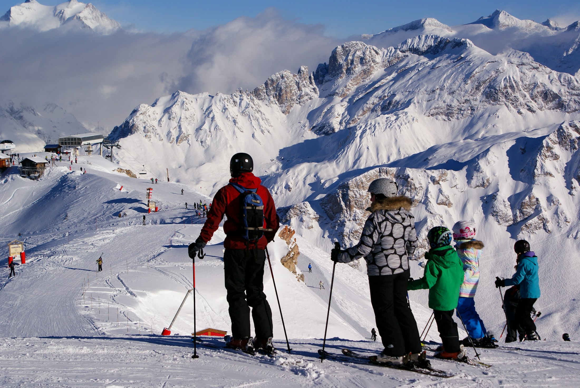 Skiers in motion on a snow-covered slope above Courchevel