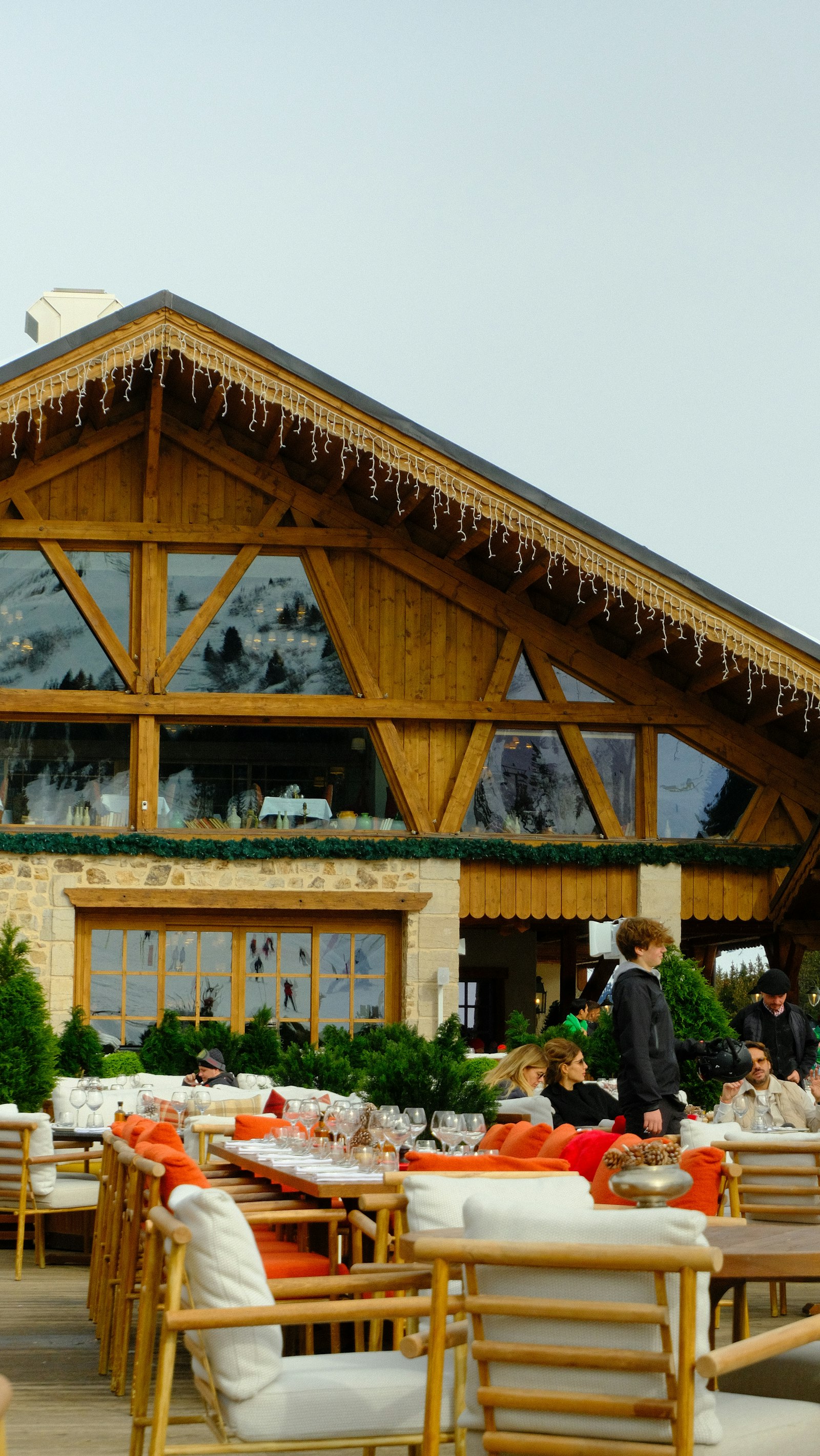 People gathered at tables in the village square of Courchevel 1850